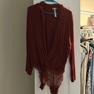 Long sleeve maroon body suit/button up shirt.